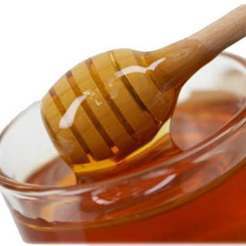 honey dripping from honey stick