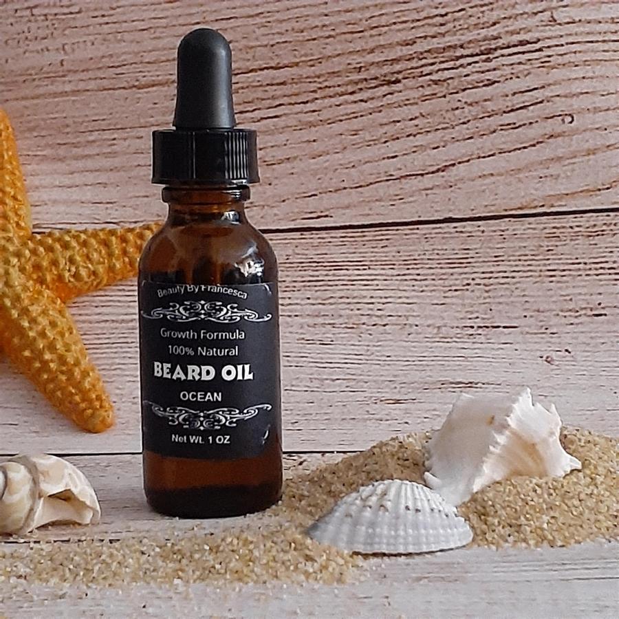ocean beard oil displayed with sand and sea shells