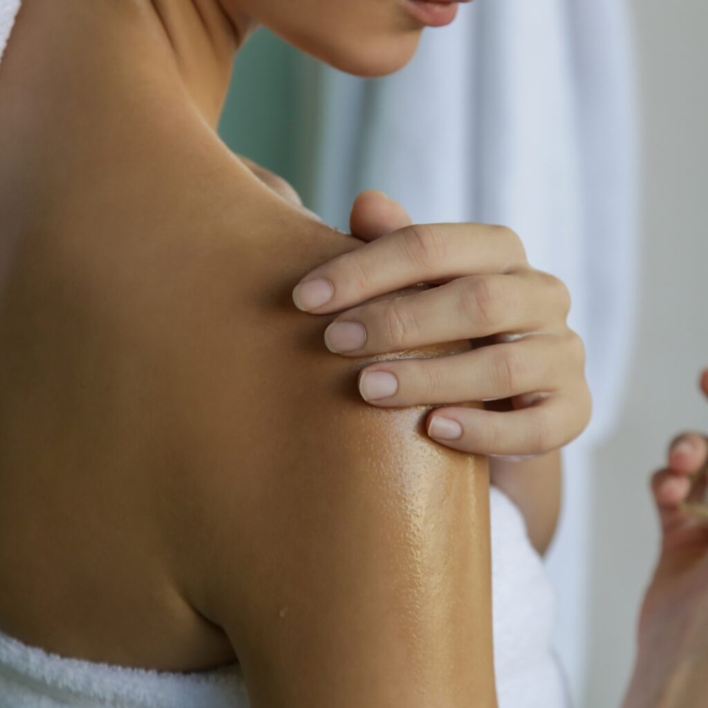 woman applying lavender body oil