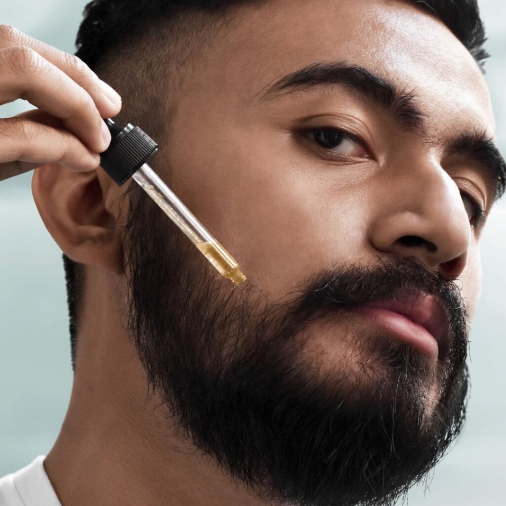 man applying beard oil