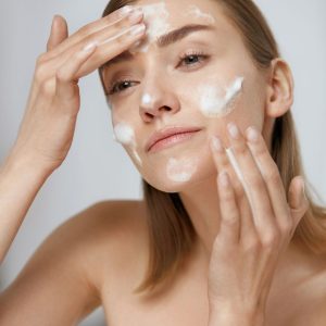 woman using coconut milk as a facial cleanser