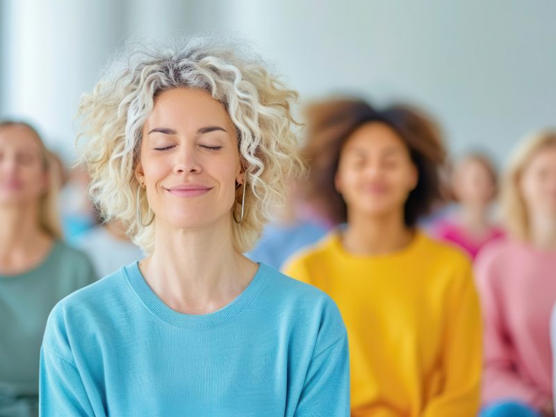 Woman meditating representing Pillar 7 of the of the  7 pillars of holistic skincare, Mindful Practice.