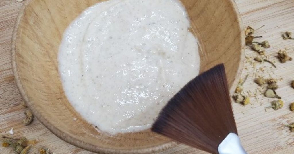 Hydrating Yogurt and Chamomile Face Mask in bowl with styled with mask brush