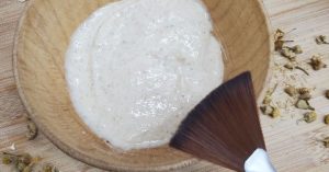 Hydrating Yogurt and Chamomile Face Mask in bowl with styled with mask brush