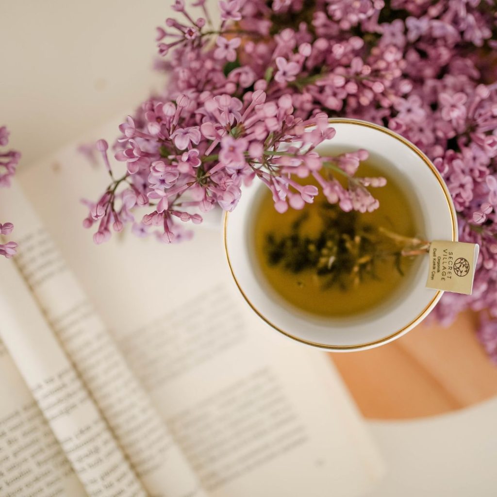 cup of herbal tea surrounded by flowers
